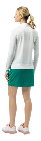 SanSoleil SOLMELANGE 1/4 zip long sleeve mock in white with varsity green and pink trim, featuring printed design and long sleeves.